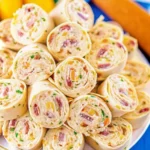 Platter of easy Crack Chicken Pinwheels appetizers with creamy filling.