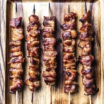 Easy grilled thai coconut chicken skewers – juicy, charred, with a sticky honey glaze and peanut sauce